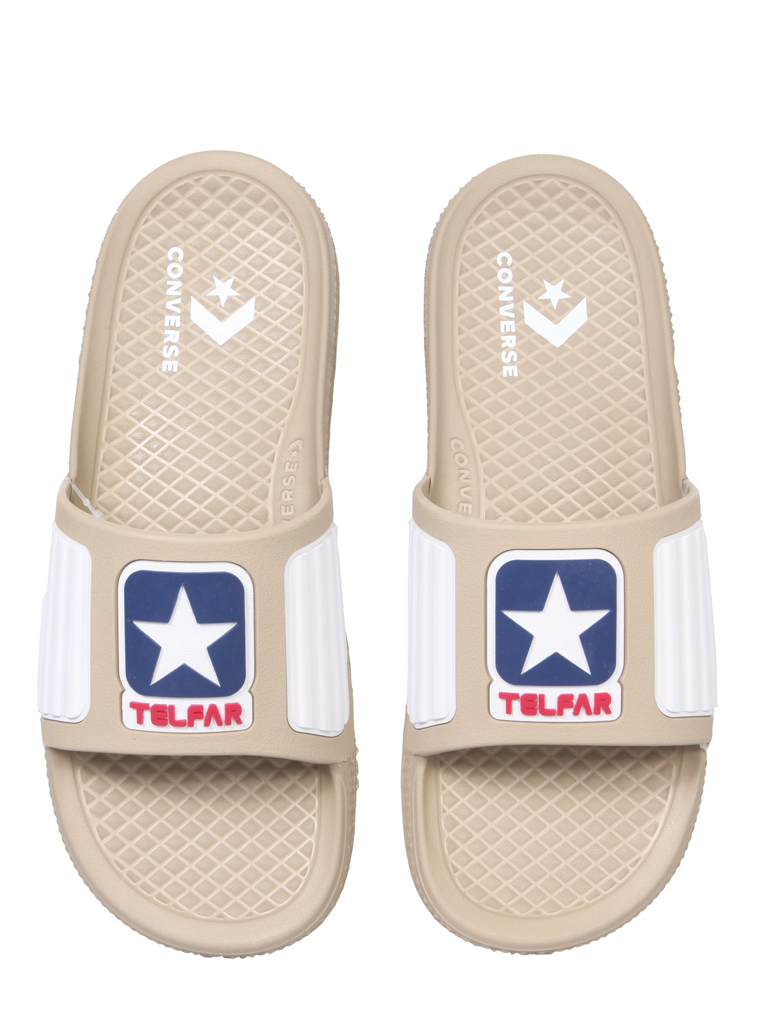 Telfar Converse rubber slide sandals with logo.