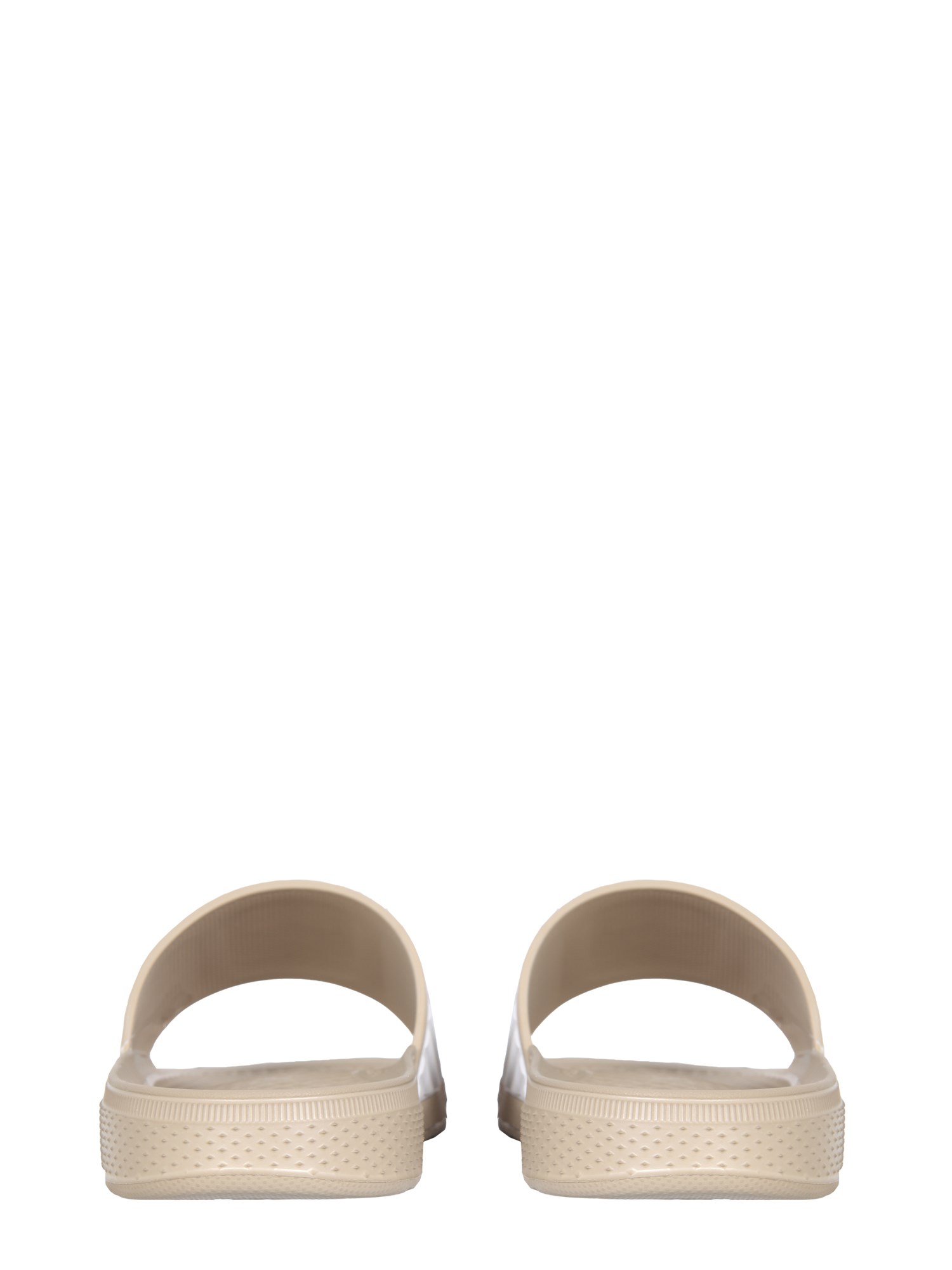 Telfar Converse rubber slide sandals with logo.